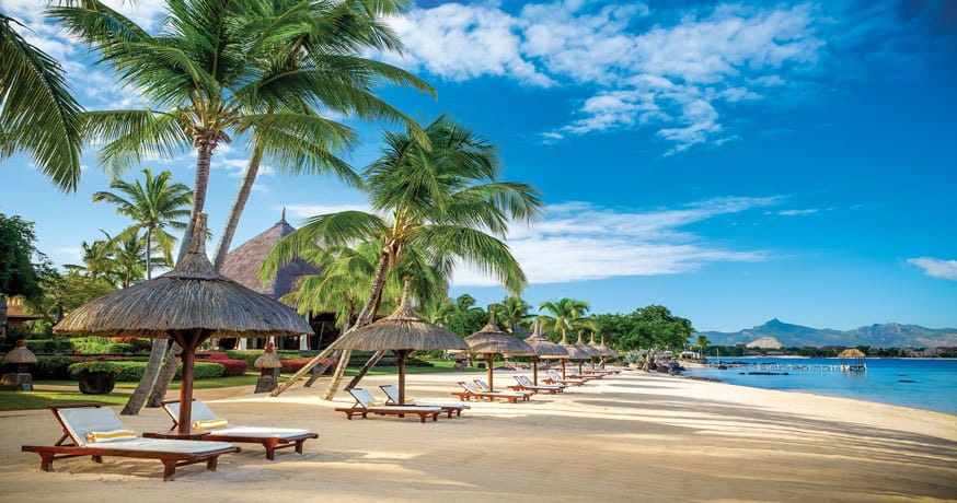 The golden beach with sunloungers at The Oberoi Mauritius
