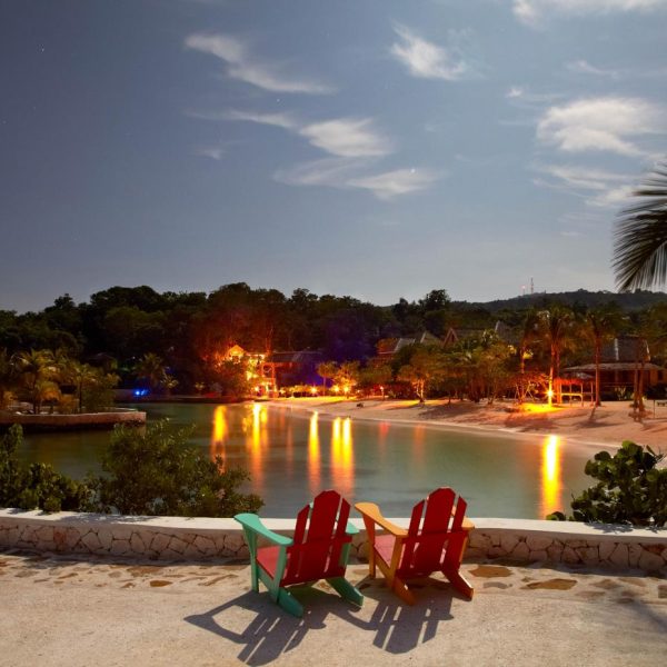 View of the beach and lights in the evening at GoldenEye Boutique Resort in Jamaica.
